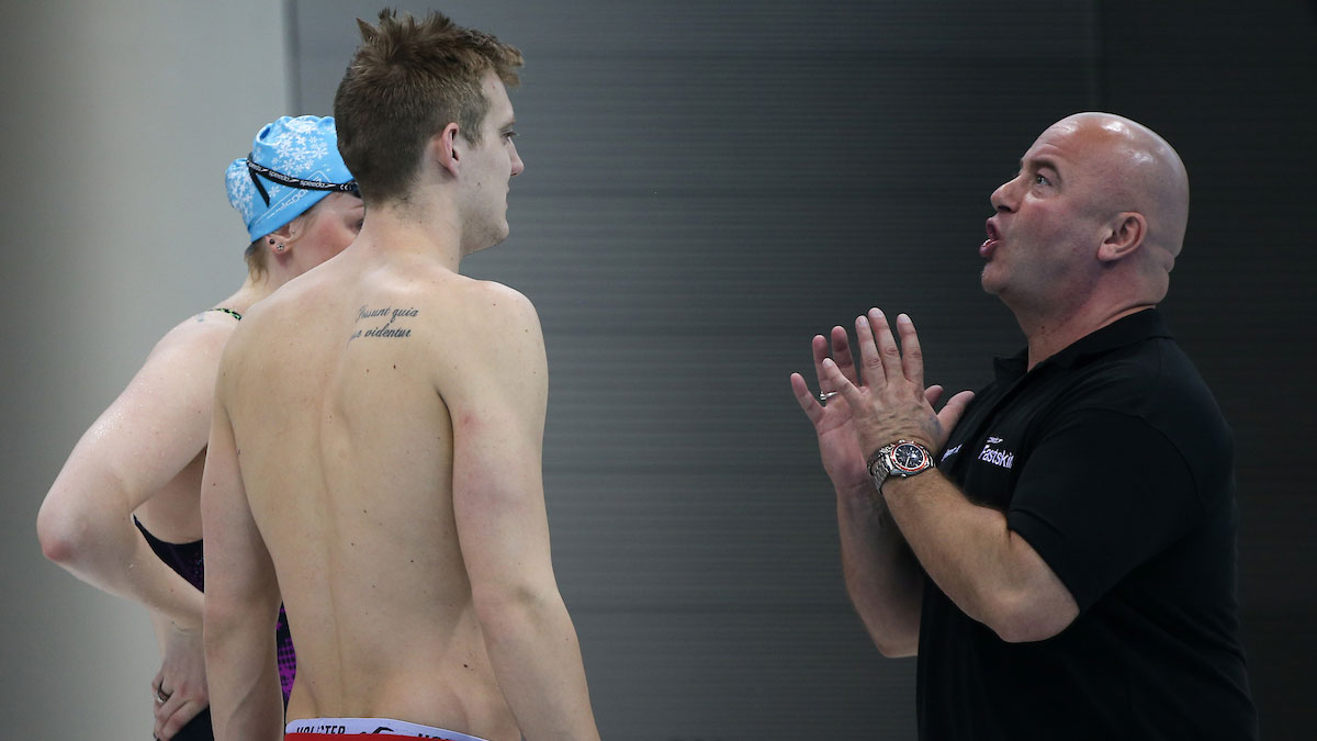 Swimming coach Dave McNulty talking to Andrew Willis