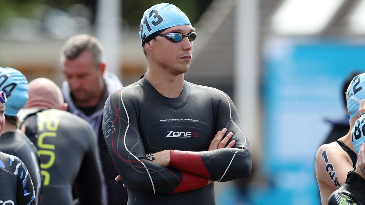 Open water swimmer Grant Turner with arms folded at an open water event