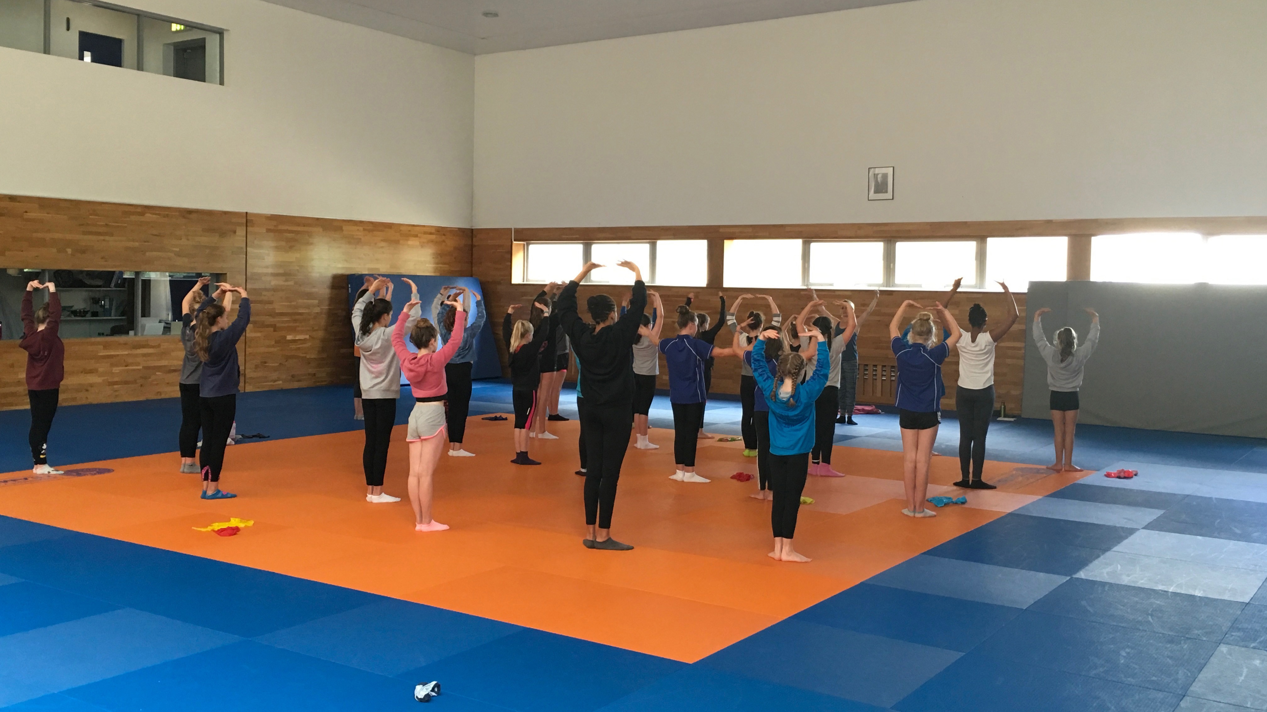 Young synchronised swimmers training on dry land